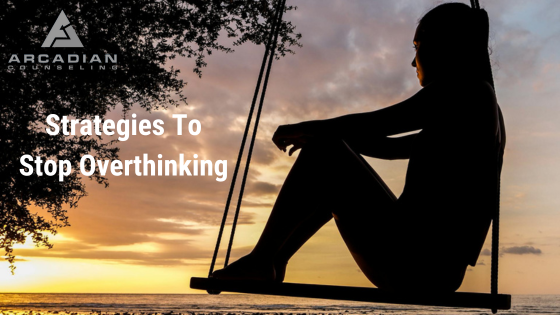 a silhouette of a woman sitting on a swing